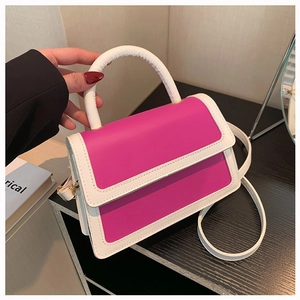 Contrast pink and white leather crossbody handbag with handle and gold buckle