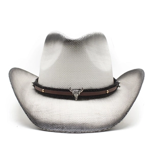 Detail of silver woven cowboy hat featuring a leather band and metal bull head skull charm