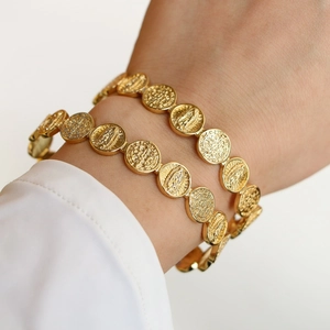 Adjustable gold plated brass religious coin bracelet featuring San Benito and Guadalupe medallions