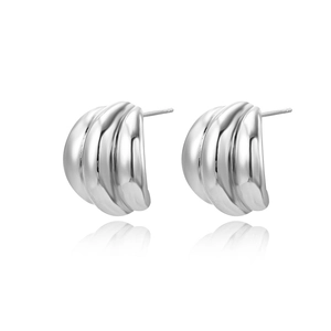 Detail view of silver wave texture C-shaped stud earrings with reflective metal finish
