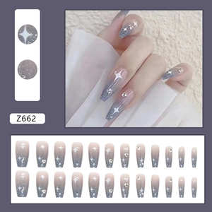 Blue gradient press-on nails with glitter and rhinestones in a medium-long coffin shape