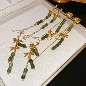 Bamboo style tassel earrings with green jade texture and pearls in a classic Chinese design