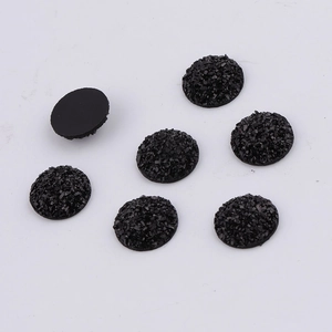 Detailed view of 14mm round black resin druzy flatback charms with shimmering texture