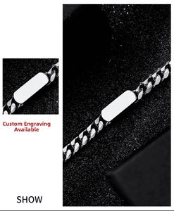 Macro shot of silver titanium steel curb chain bracelet with customizable engraving plate