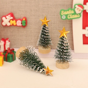 Miniature Christmas trees with snow effect and gold stars on wooden bases for DIY decor