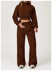 Detailed texture of thick chocolate brown cotton fabric on high-waist wide-leg sweatpants