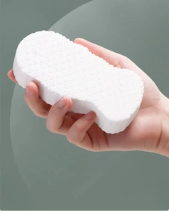 Macro shot of 3D white bath sponge texture with honeycomb pattern for exfoliation