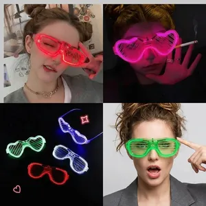 Close-up of heart-shaped and shutter LED glowing glasses in multiple bright colors