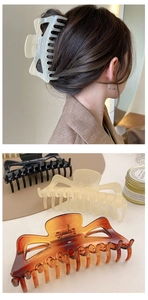 Detail of 14cm large hair claws in cream, black, and tortoise shell on a beige surface