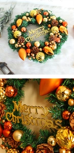 Detail of Christmas wreath with golden balls, pine cones and Merry Christmas sign