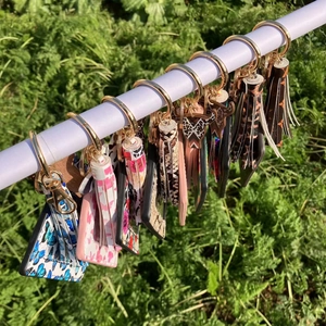 Close-up of PU leather card holder keychains with colorful patterns and tassels