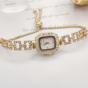 Detail of gold square watch with crystal inlay and adjustable drawstring bracelet