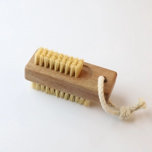 Detail of double-sided wooden nail brush with natural bristles and hanging cotton rope