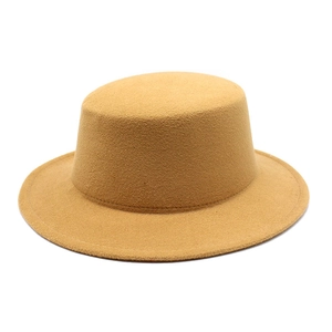 Close-up of camel wool felt flat top hat showing smooth texture and wide brim detail