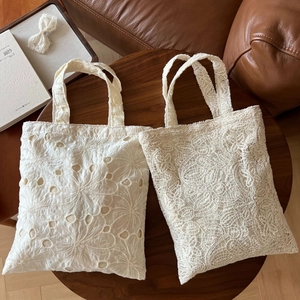 French vintage cotton lace tote bag with floral embroidery on wooden table