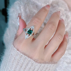 Elegant emerald cut green gemstone ring with teardrop diamonds in white gold finish