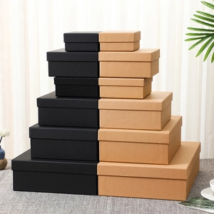 Tiered stack of black and kraft paper gift boxes in various sizes for luxury packaging