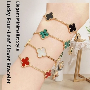Detail of four-leaf clover bracelets in red, white, green and black with gold beaded edges