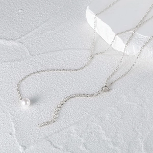 Detailed close-up of a silver freshwater pearl necklace with a delicate chain and clasp