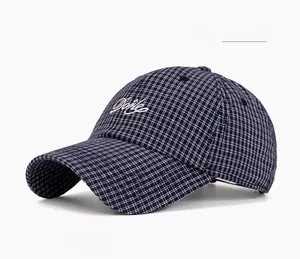 Detailed close-up of navy blue plaid baseball cap featuring white Done embroidery