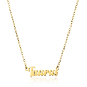 Macro shot of 18K gold plated Taurus zodiac necklace with script font pendant detail