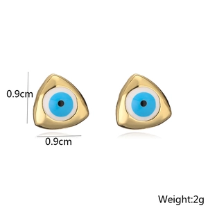 Macro detail of 18K gold plated evil eye triangle studs with dimensions 0.9cm and 2g weight