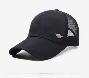 Detail view of the breathable black mesh fabric and gold metal wing logo on the baseball cap
