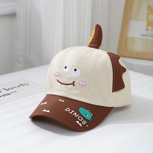 Detailed close-up of kids' baseball cap with 3D horns and dinosaur embroidery details