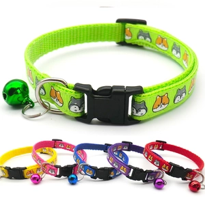 Detail of adjustable pet collars with colorful bells and cute cartoon dog print patterns