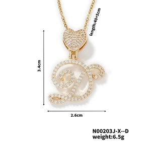 Macro shot of gold letter D pendant with heart detail and inlaid white zircons
