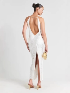 Elegant white backless maxi dress with fringe details and a sleek slim fit profile