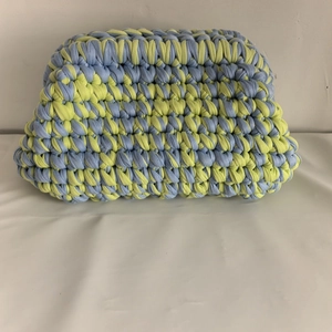 Detail of blue and yellow hand-woven crochet bag made with thick cotton fabric yarn