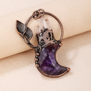 Detailed view of bohemian amethyst moon pendant with bronze leaves and quartz clusters
