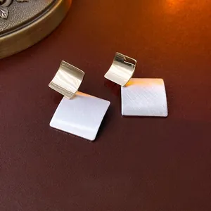 Minimalist geometric square stud earrings with gold mirror and silver brushed textures