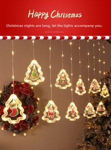 Close-up of LED Christmas curtain lights with Santa and reindeer inside tree-shaped charms