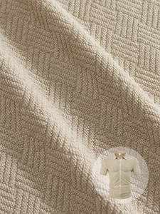 Close-up of the 3D waffle texture on a men's beige short-sleeve knit shirt