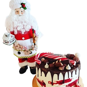 Christmas Santa doll in chef outfit with gingerbread house and chocolate drip cake decor