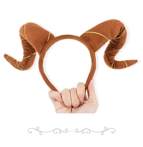 Detail view of brown plush Halloween horn headband with golden thread decorations
