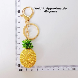 Close-up of sparkling yellow rhinestone pineapple keychain showing 11cm size measurement