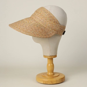 Detailed texture of multi-colored woven straw sun visor on a professional display stand