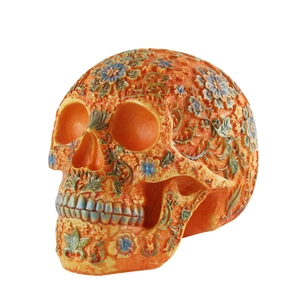 Detail of a Viking resin mug with skull relief, green leaves, and colorful floral patterns