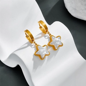 Elegant gold star-shaped earrings with pearl-white inlay on a stylish white wavy stand