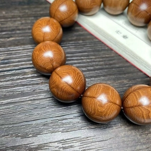 Macro detail of natural Wutai Mountain wood beads with symmetric hawk-eye patterns