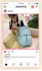 Detail of light blue school backpack featuring cute cartoon bear pattern and nylon material