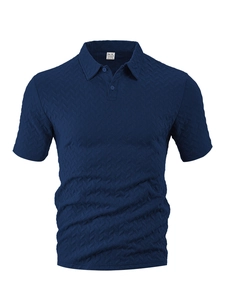 Macro shot of navy polo shirt featuring textured herringbone jacquard fabric and collar detail