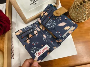 Detailed interior of tri-fold wallet showing three card slots and maple leaf print