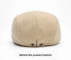 Detail view of the beige wool beret back featuring adjustable double metal snaps