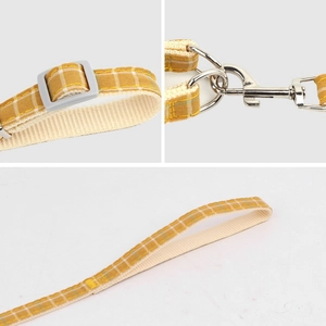 Adjustable plaid dog harness with yellow and white nylon webbing and metal swivel hook