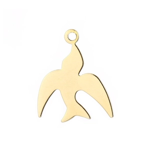 Macro shot of a minimalist gold swallow bird pendant with a polished metal finish