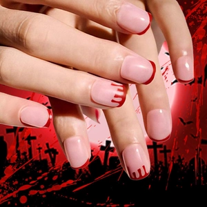 Close-up of nude pink French manicure with blood drip patterns for Halloween vibes